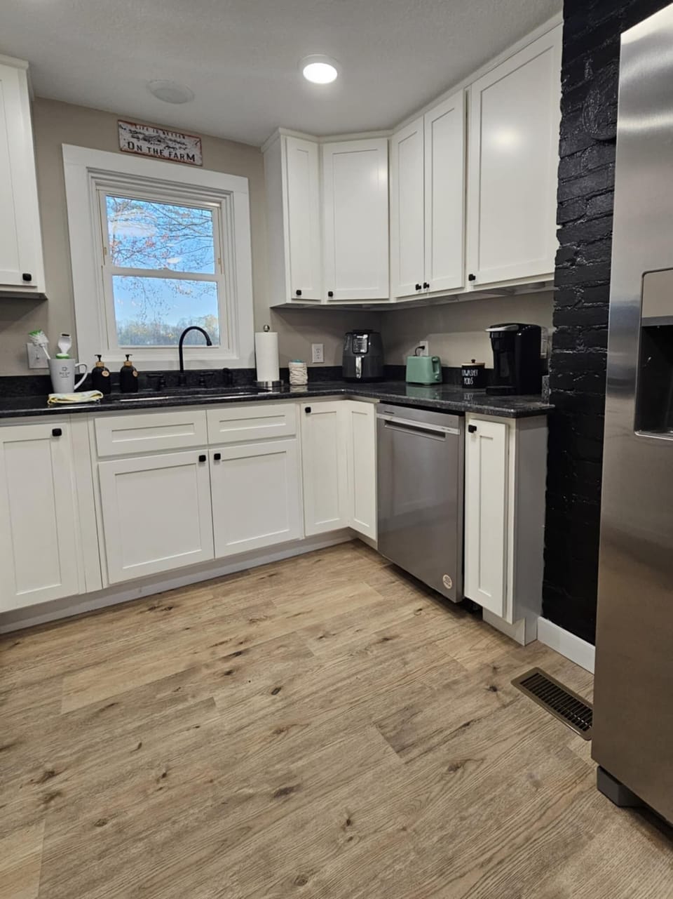 This kitchen is fully equipped with plenty of dishes, cooking utensils, and more