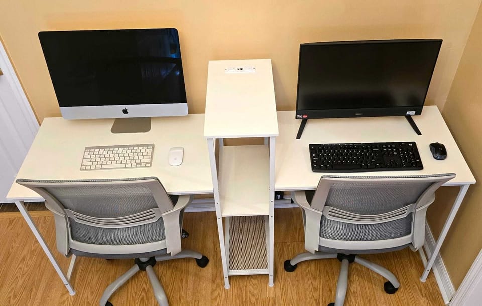 Office equipped with Apple computer and Windows computer.