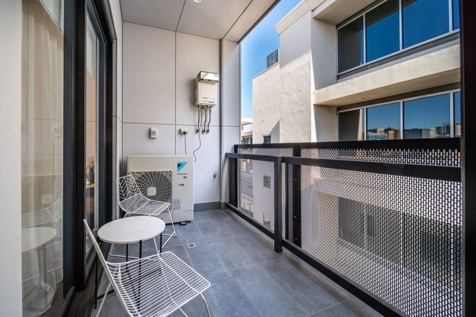 Step out from the third bedroom to a quiet outdoor nook, perfect for a breath of fresh air or a moment of calm between plans.