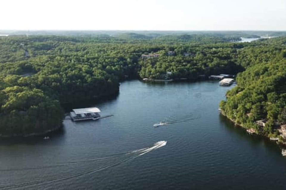 This expansive aerial view showcases the stunning Lake of the Ozarks, surrounded by vibrant fall foliage, offering a truly picturesque setting.