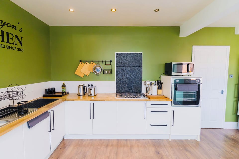 Chopping boards, kettle, toaster, tea, coffee, sugar, olive oil