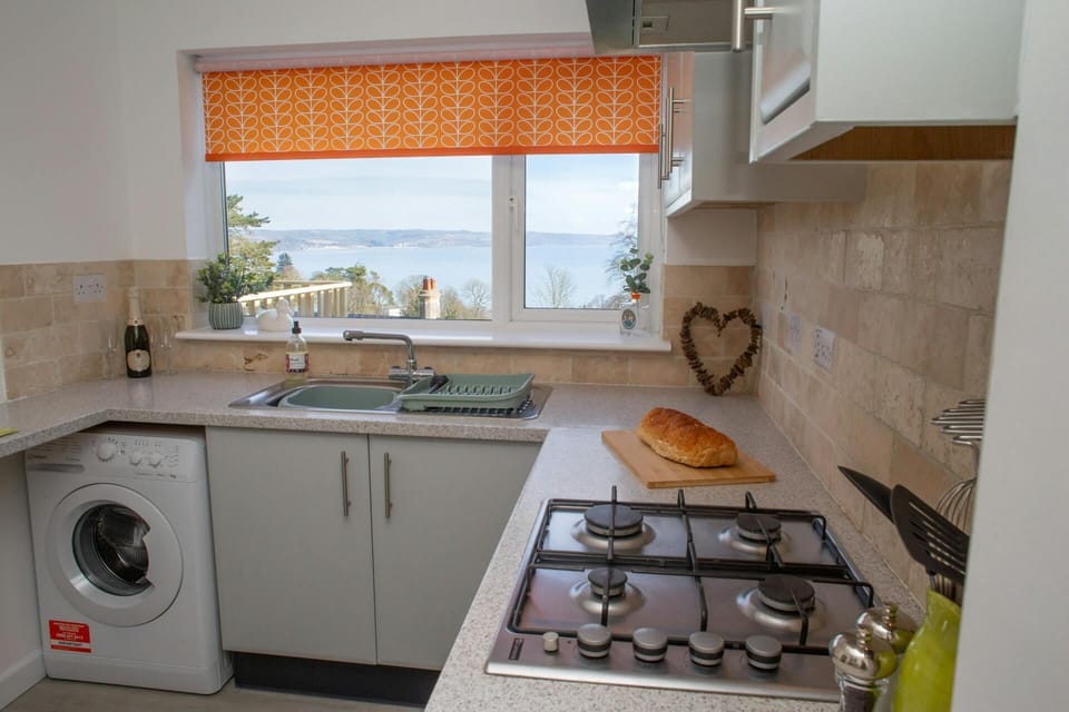Kitchen with gas hob, washing machine and sea views