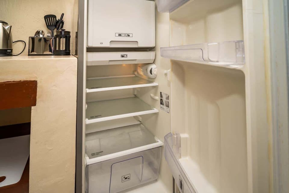 Full-size refrigerator with freezer — perfect for storing your groceries and keeping ice ready for sunny Cancun days ❄️🌞
