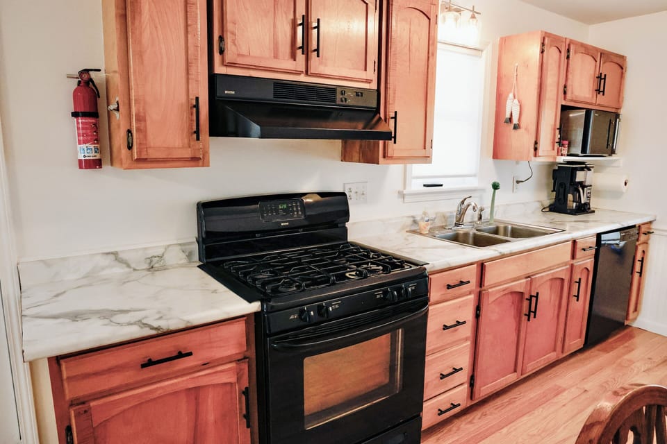 Full kitchen with stove, dishwasher, and coffee maker