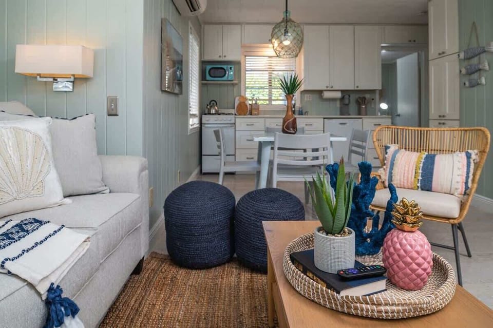 Living space features a plush sofa, accent chairs, and a coffee table..