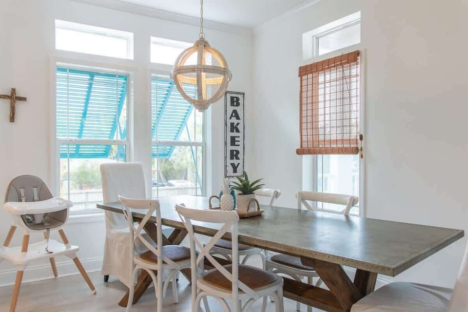 Full kitchen with bar seating, stainless steel appliances, and elegant pendant lights.