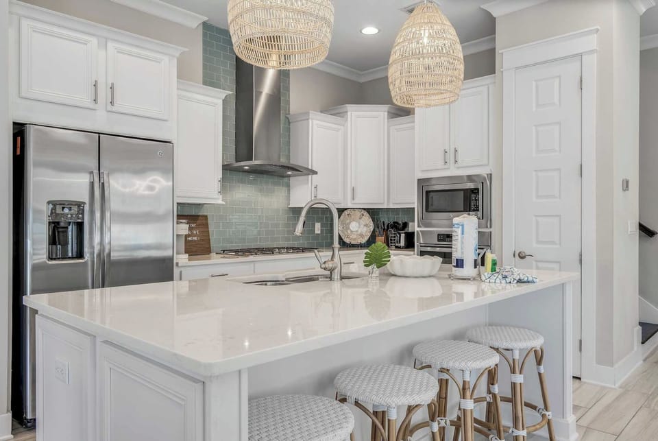 Large gourmet kitchen perfect for cooking together. Island features seating for four.
