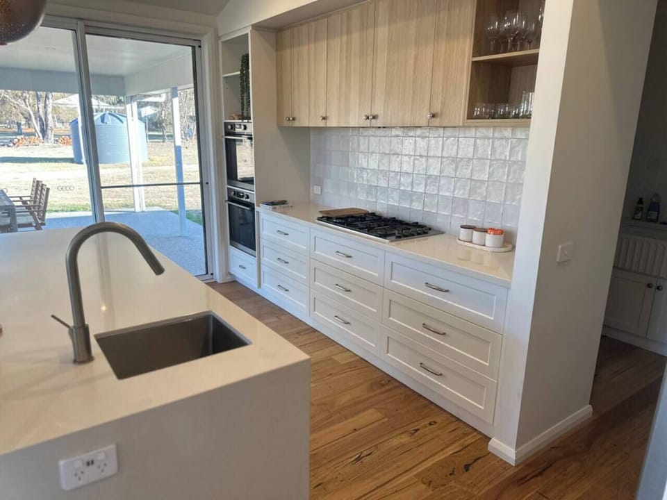 Spacious kitchen, butler's pantry, dishwasher, large fridge/freezer, gas stovetop, two ovens, large workspace / serving area