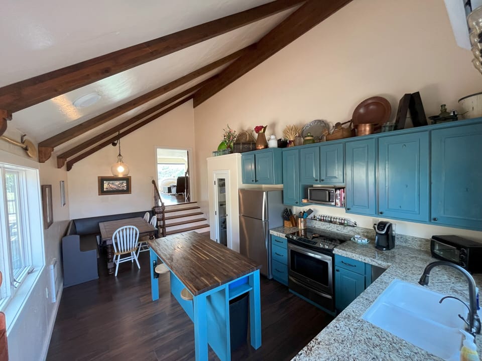 Kitchen and dining area. Table seats 6 and there are 2 stools. 