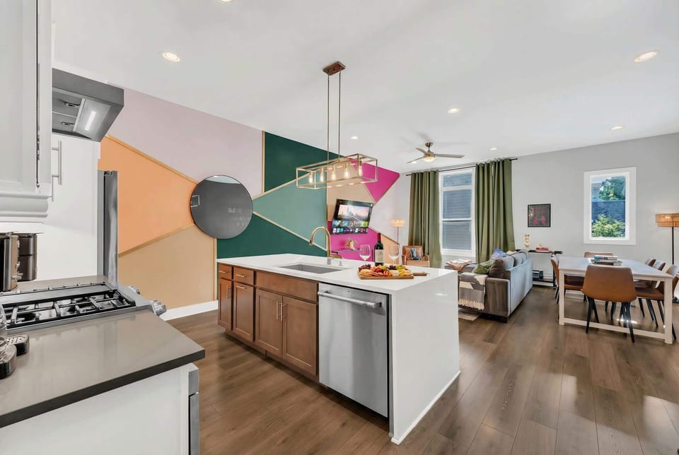 The open-concept kitchen flows directly into the living room, so you're never cooking alone; the island stovetop puts you right in the middle of where the group gathers