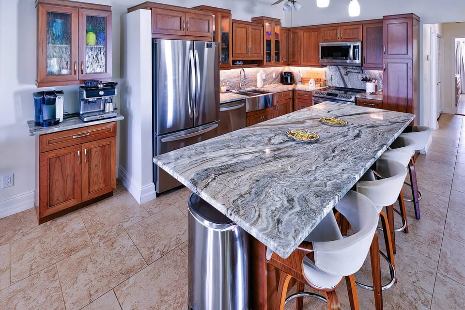 The beautiful kitchen boasts stainless steel appliances and sleek granite countertops, making meal preparation a pleasure.