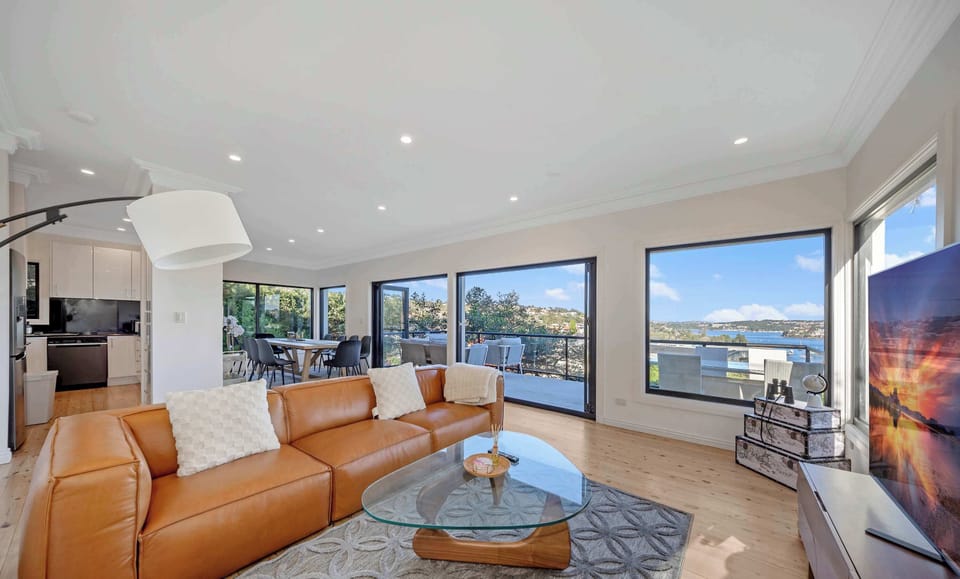 Main living area with leather sofa seating and expansive water views.