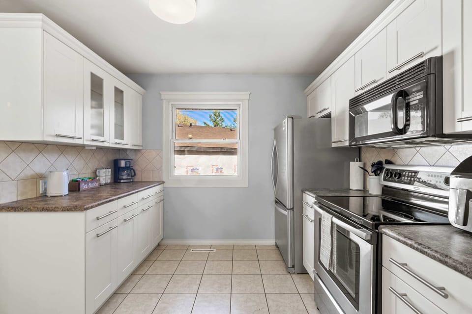 Chef-ready kitchen with essentials, from glasses to whisks.