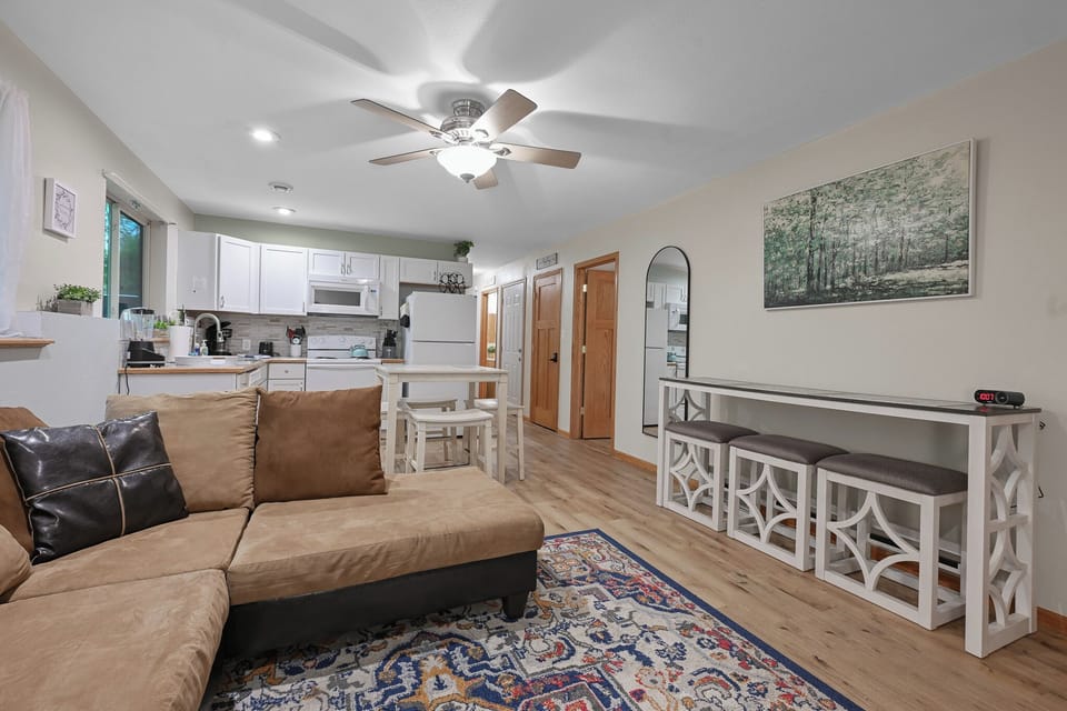 Cozy living area with a spacious sectional and open kitchen—perfect for relaxing and gathering.