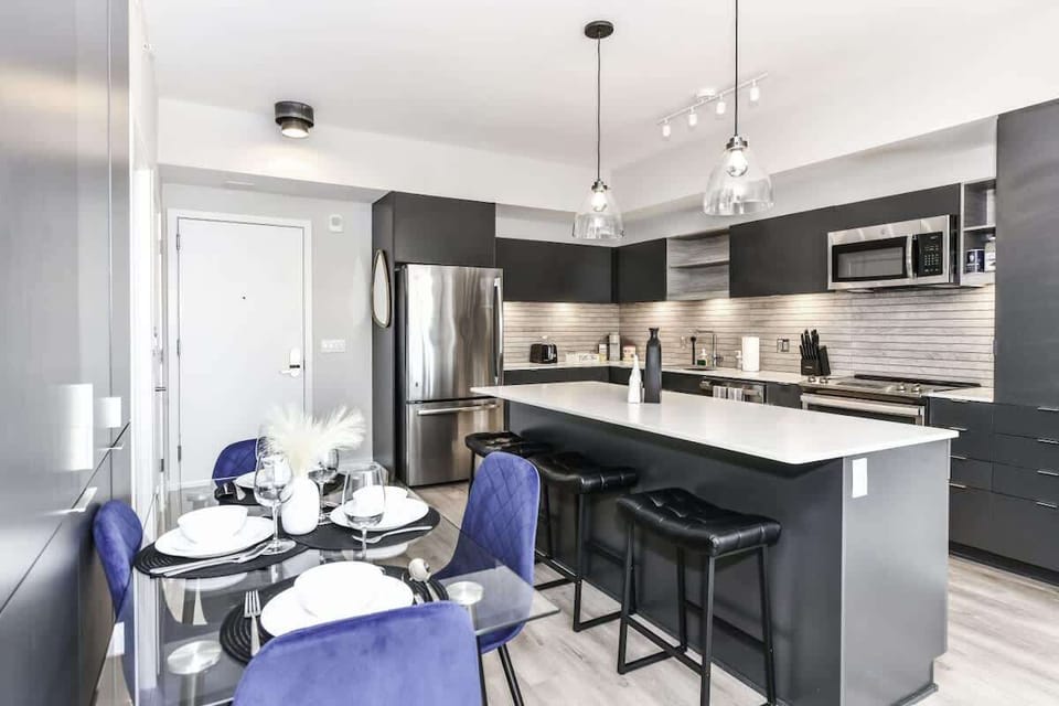 Fully equipped kitchen with a breakfast counter (seats 3) and a dining area (seats 4), plus a high chair available for little ones.