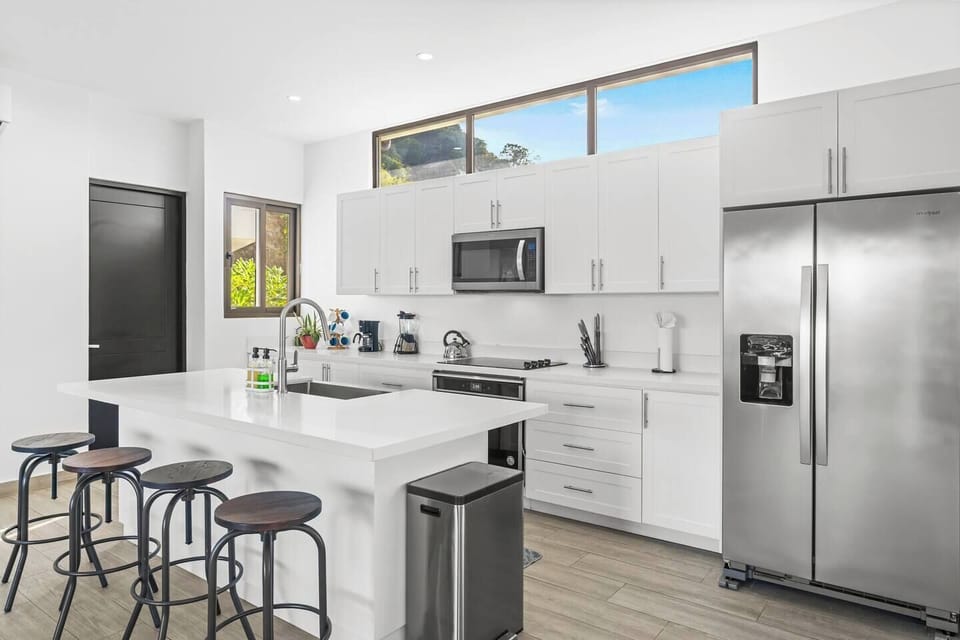 The large kitchen features a breakfast bar and stainless steel appliances.  