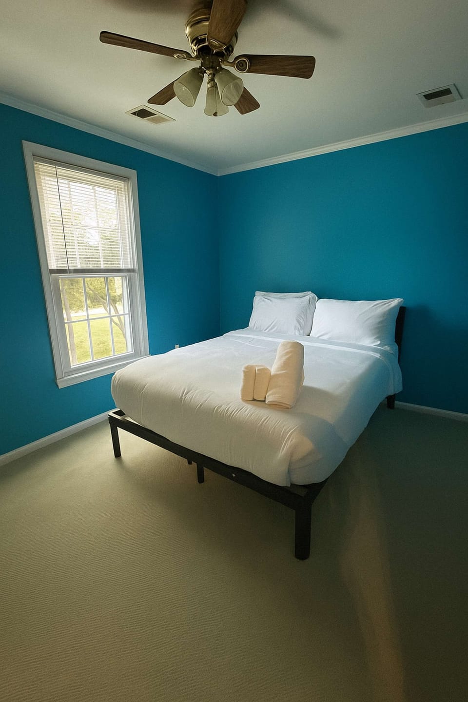 A simple stylish space with blue tones and a queen bed for comfort.