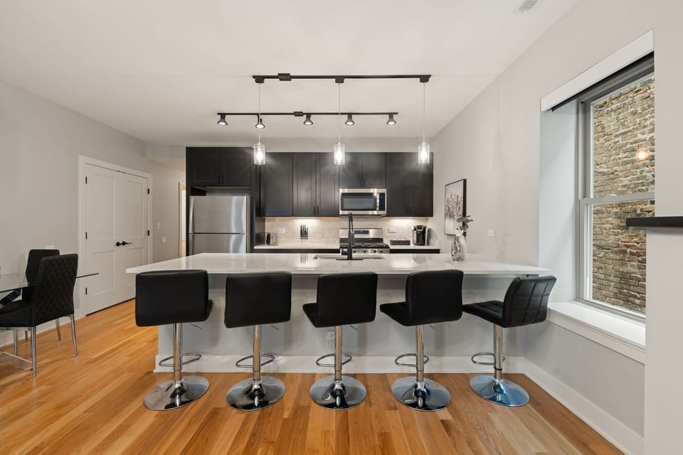 Spacious kitchen framed by warm wood tones & natural light.
