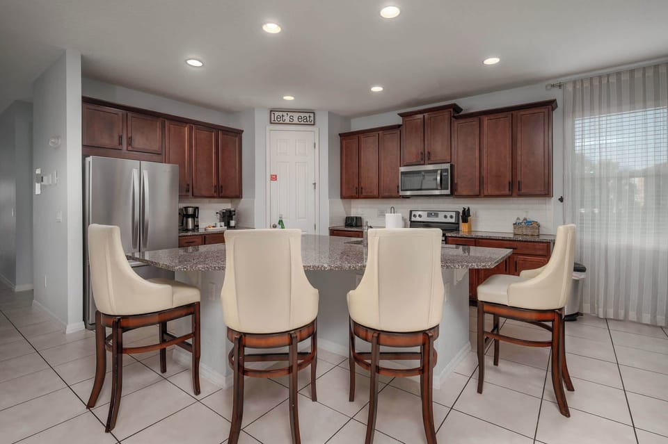 Enjoy the convenience of a fully equipped kitchen with a large island and modern appliances in our Solara Resort home.