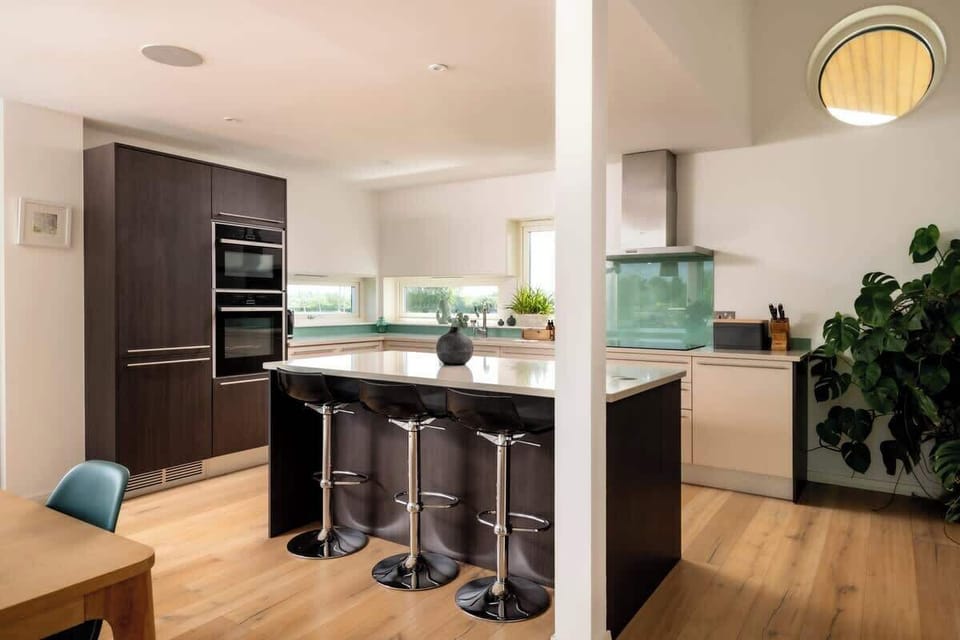Perch at the island with a coffee, chat as dinner simmers, or just watch the boats go by. This is the quiet heart of the home - where mornings flow and conversations linger.