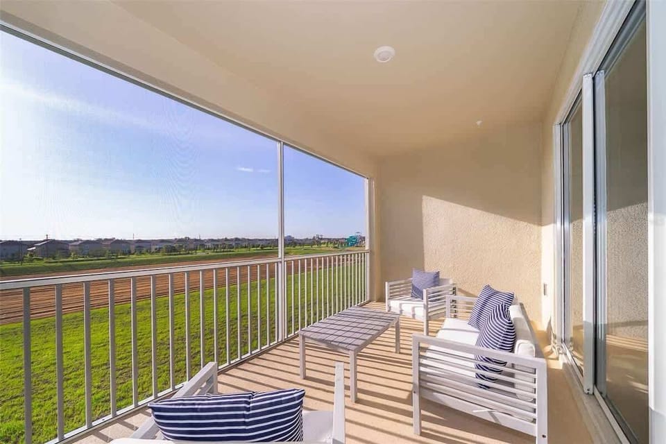 Outdoor patio with dining set and lounge chairs — enjoy alfresco meals in sunny Florida