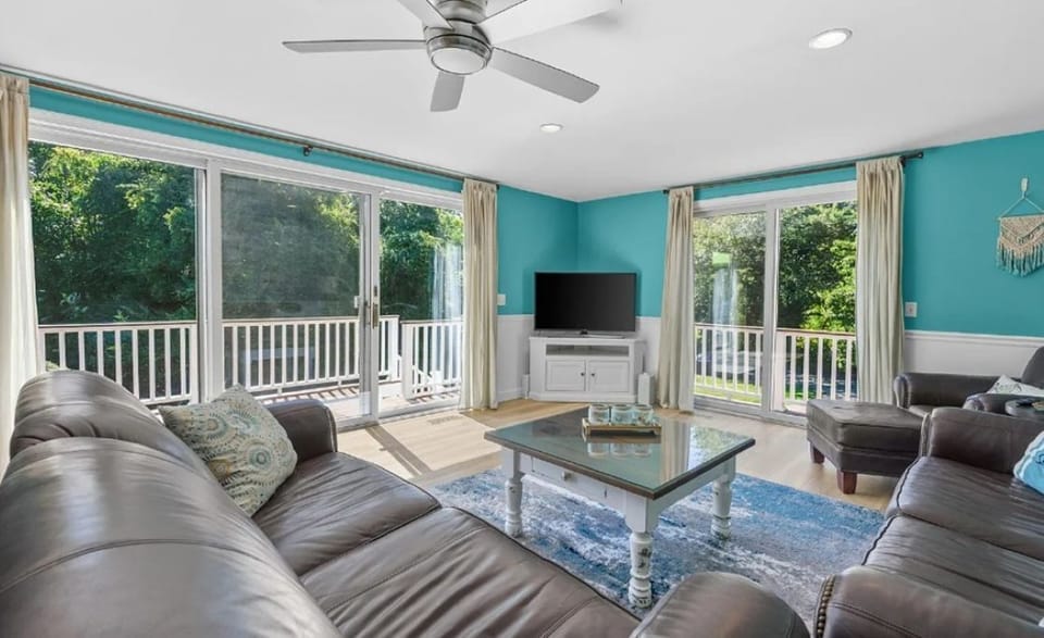 Bright living area with wrap-around deck letting the sunshine fill the room