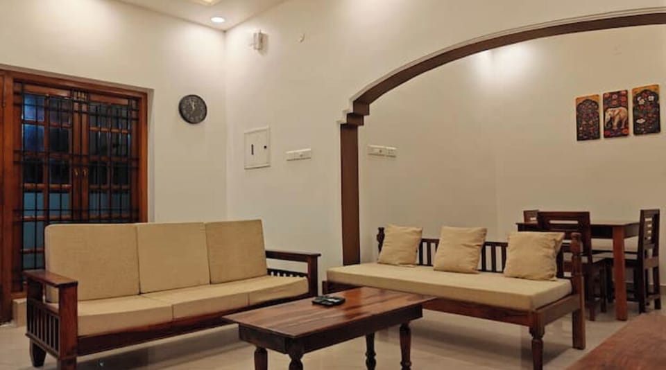 Living room seating and dining behind the arch