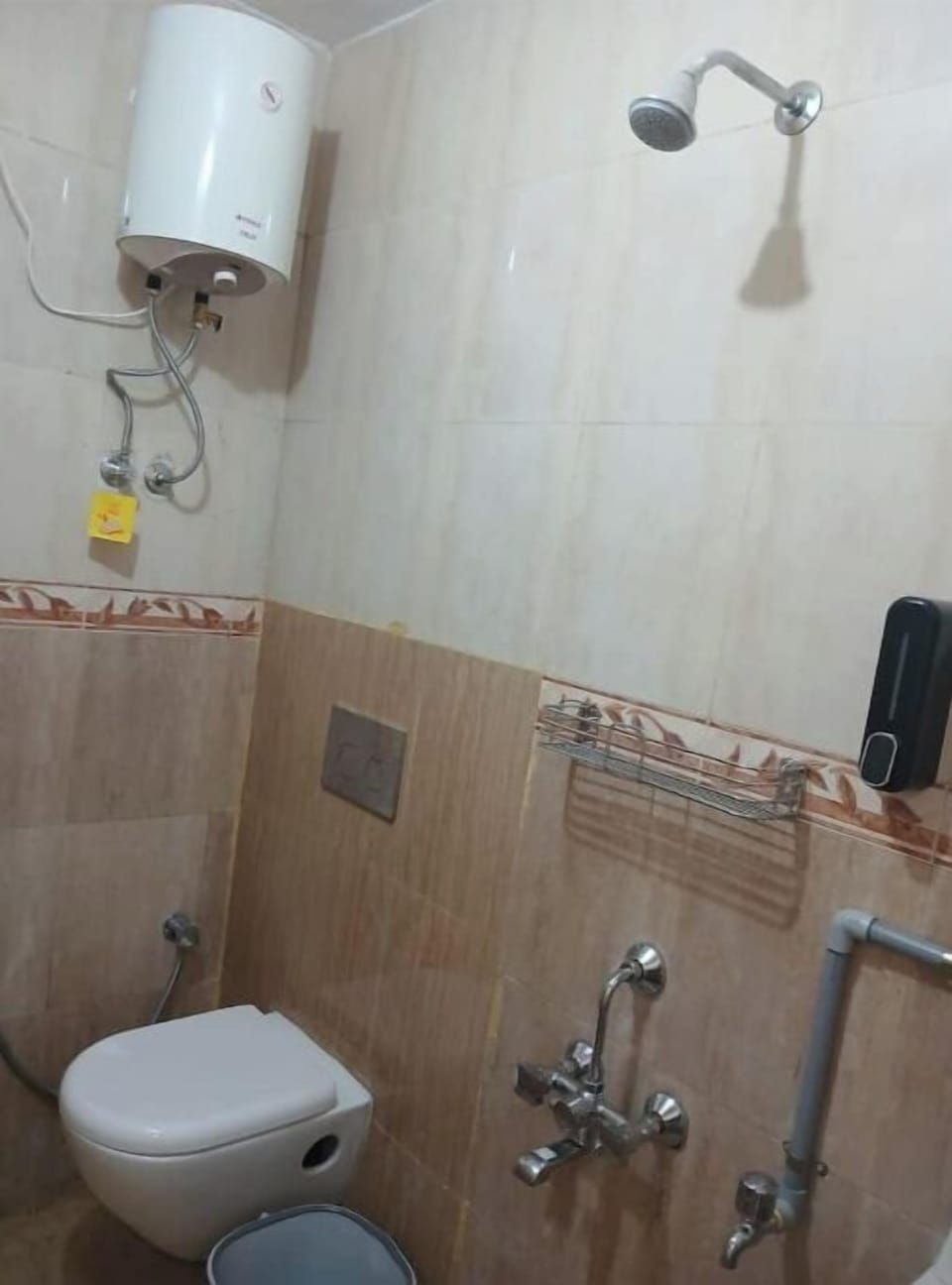 Attached bathroom, toilet, geyser, shower gel and handwash liquid soap