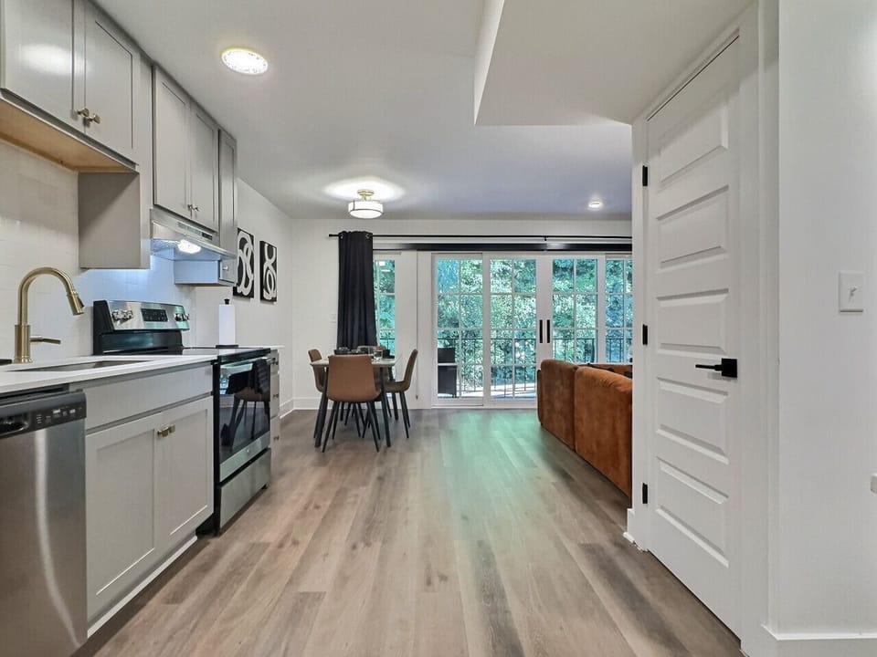 Modern kitchen with a sleek dining area, perfect for cooking, serving, and enjoying meals in style during your short-term rental stay.
