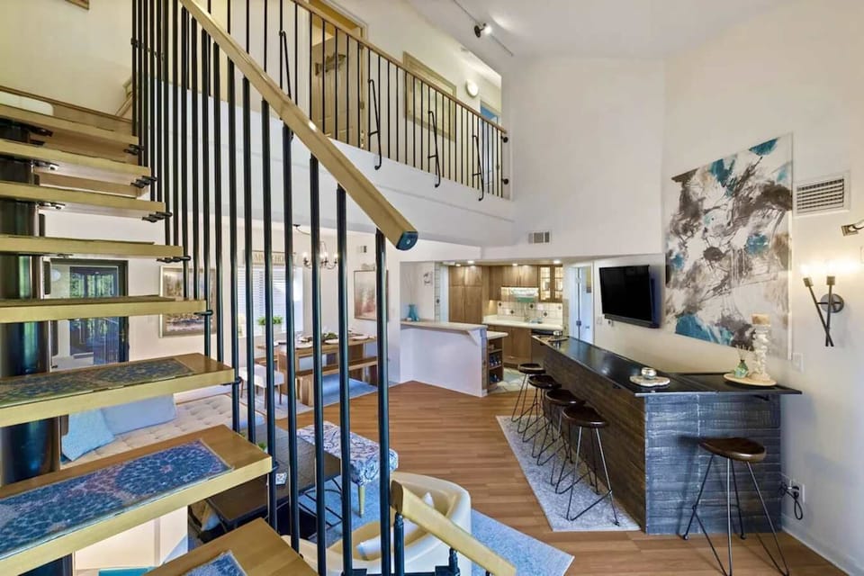 Living room with stairs to second floor bedrooms and bathroom