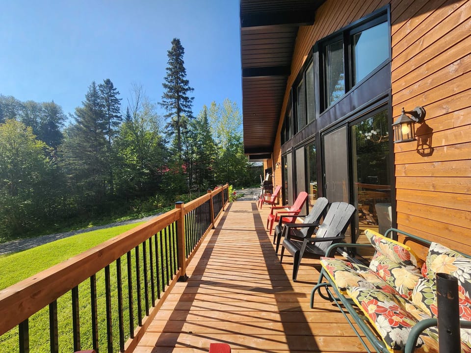 Enjoy serene views while lounging on colorful chairs under the sun!
🇫🇷 Retraite sur le patio : Détendez-vous sur des chaises colorées en admirant la vue apaisante, baignée de soleil et de douceur, pour un moment parfait de relaxation en plein air.