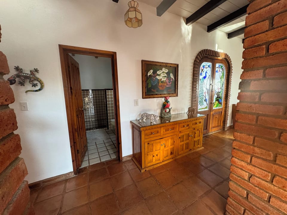 Hallway with bath and courtyard doors.