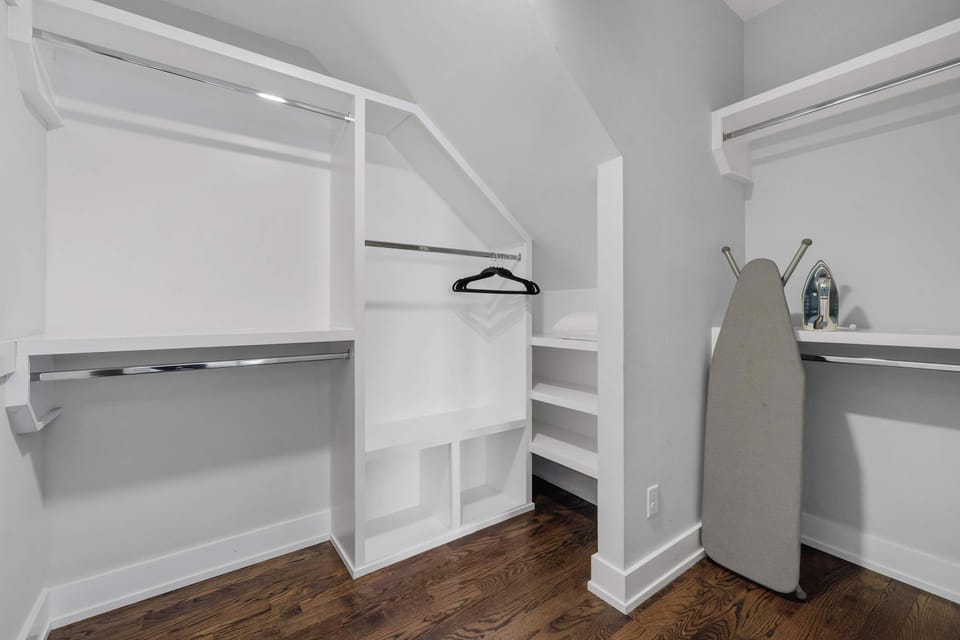 Located on the 3rd floor, this elegant and cozy primary suite features a plush king bed, Smart TV, stylish floral accent wall, a spacious walk-in closet, and an ensuite bathroom