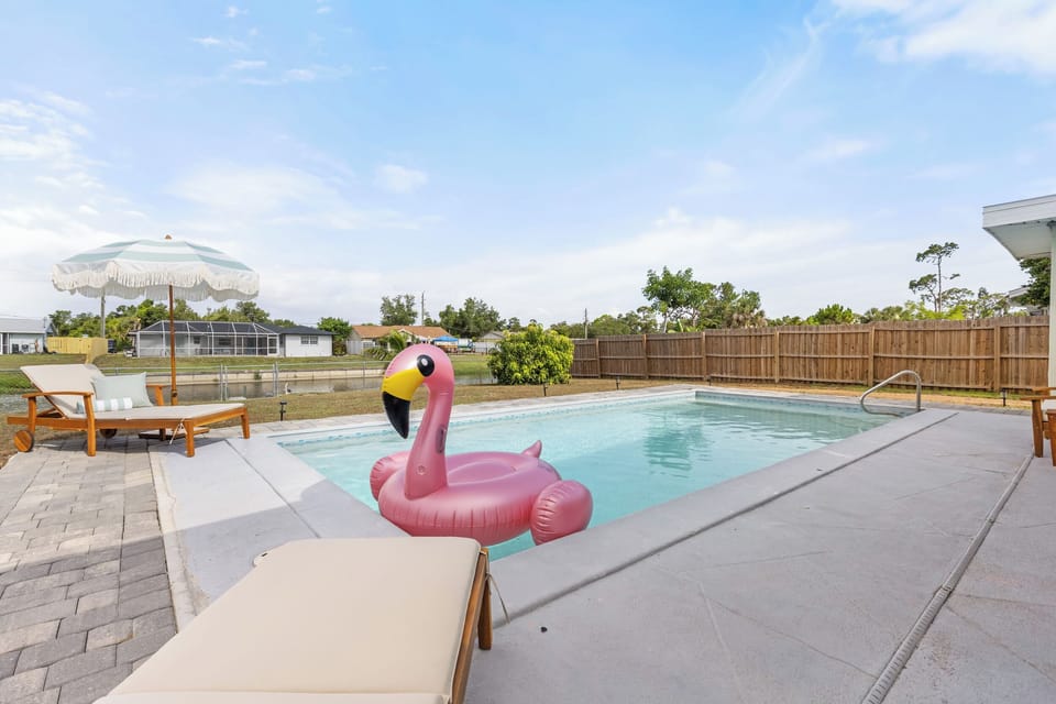 Pool with inflatable and sun loungers