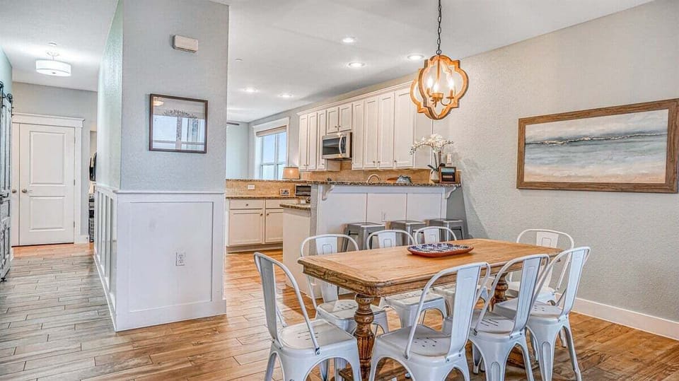 Open kitchen and dining space with breakfast bar seating