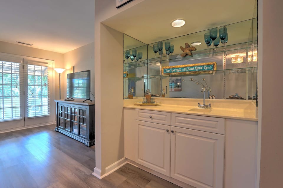 Living area with sectional seating, TV, and wet bar 