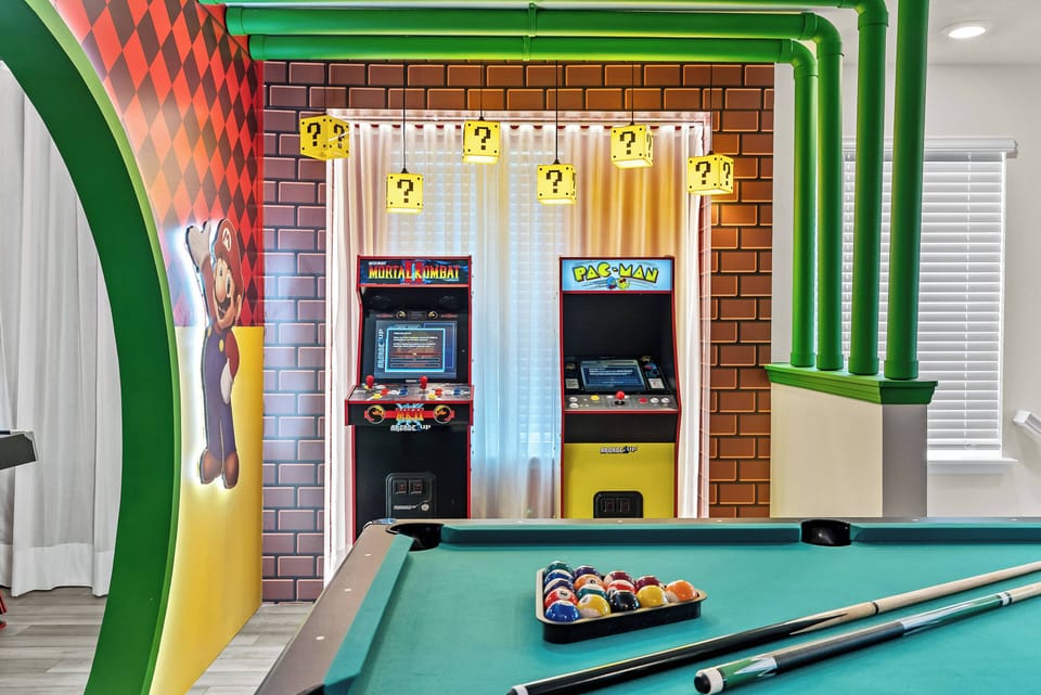 Step into a vibrant game room featuring a green pool table that invites friendly competition. Retro arcade machines stand ready for hours of entertainment, set against a playful backdrop of colorful decor and whimsical lighting.