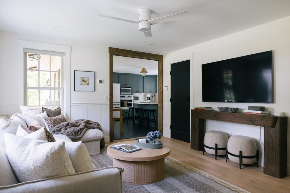 Cozy meets connected – Lounge in style with plush seating, a large smart TV, and an open flow into the heart of the kitchen