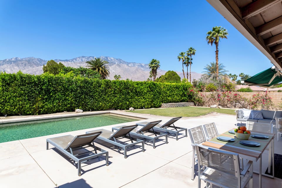 Backyard, pool, spa, and dining area with mountain views
