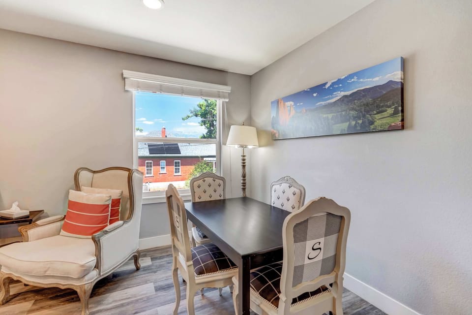 Charming dining area with natural light and a view, perfect for meals or a casual workspace








