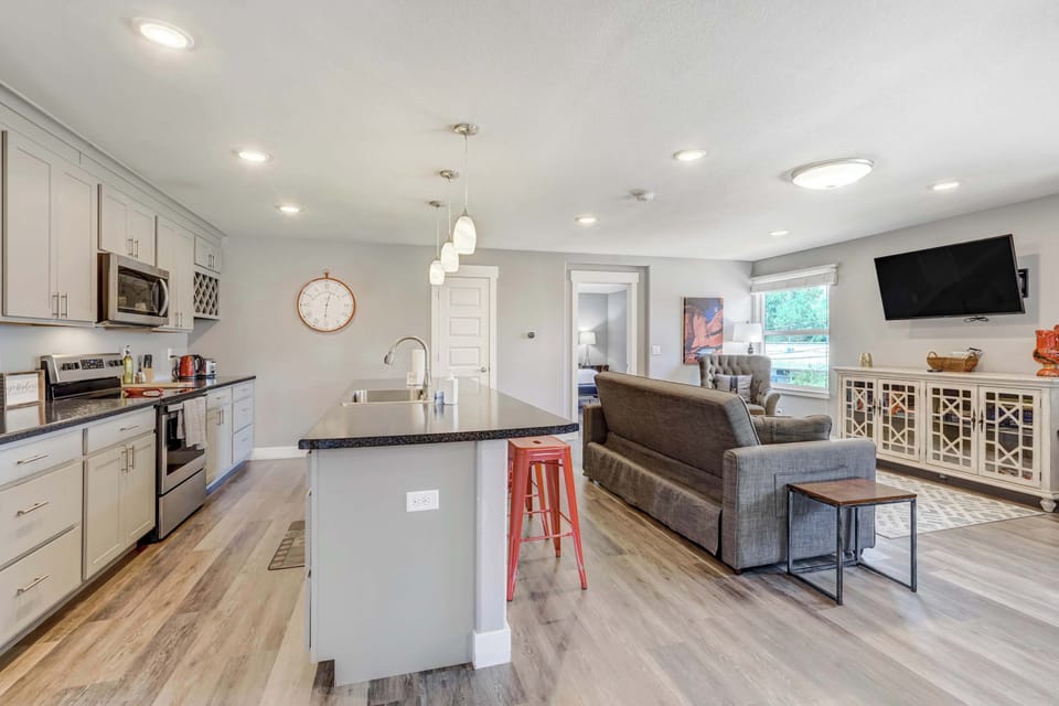 Modern open-concept kitchen and living area with bar seating and plenty of space to gather and unwind








