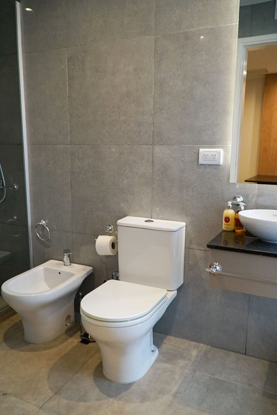 Refresh easily in a sleek, tiled bath with modern fixtures.