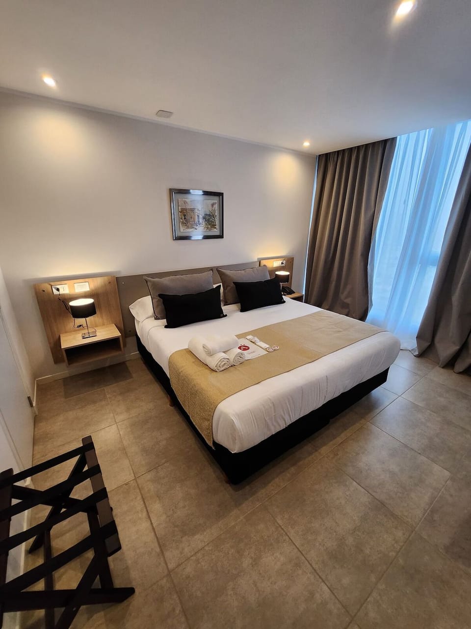 Relax in a spacious king room with calming neutral tones.