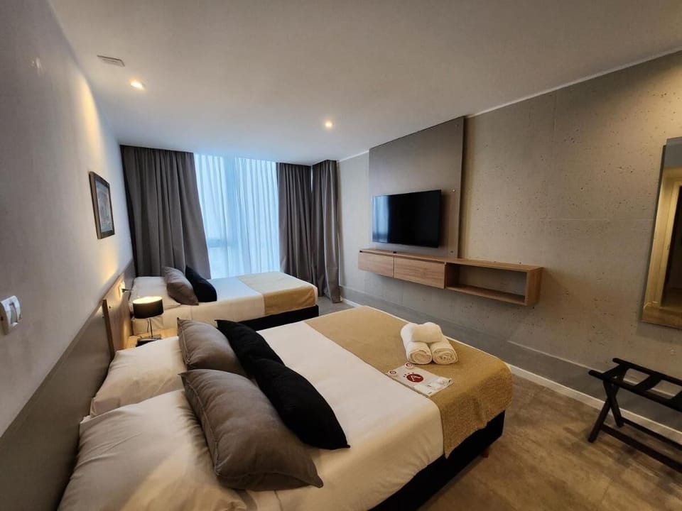 Relax into crisp linens and enjoy movies from bed.
