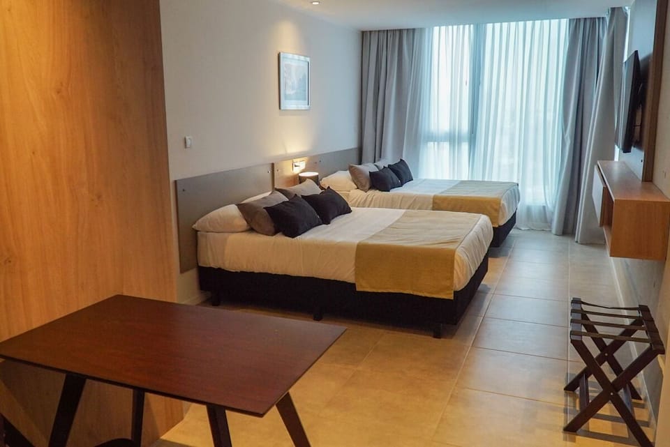 Wake up refreshed beside soft curtains and calm modern tones.