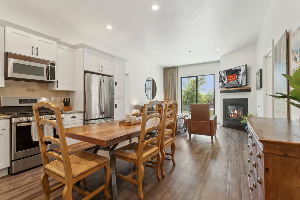 a view of the dining room table and full kitchen