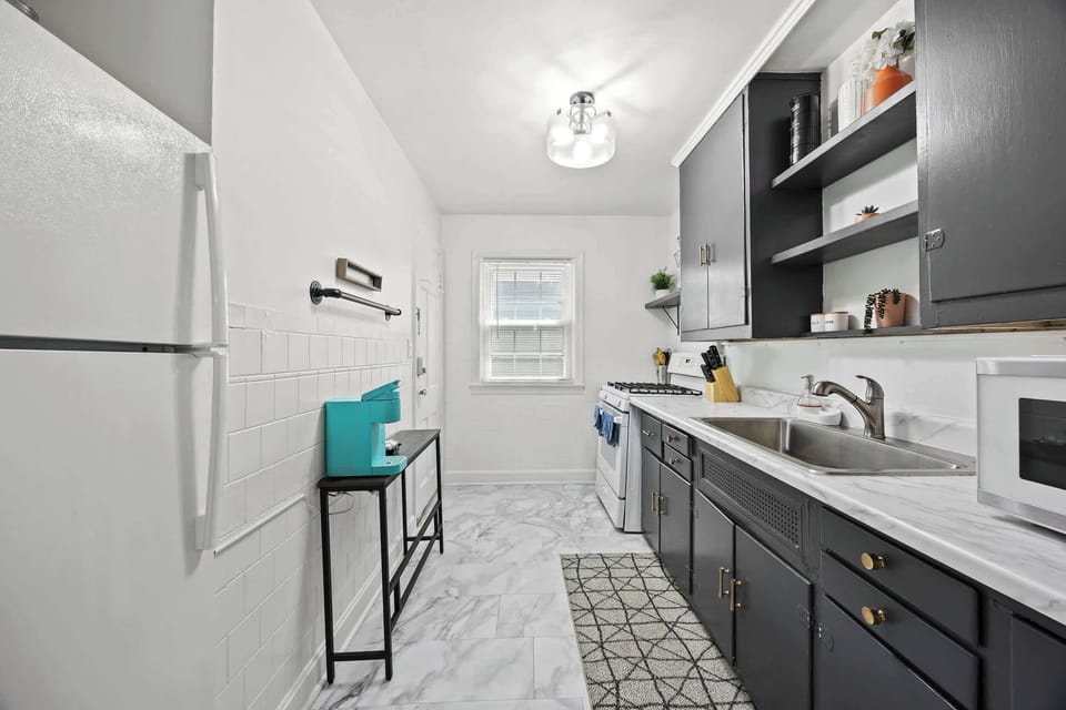 Kitchen: Unit 1 - Cook with ease in this functional kitchen featuring updated appliances and essentials.