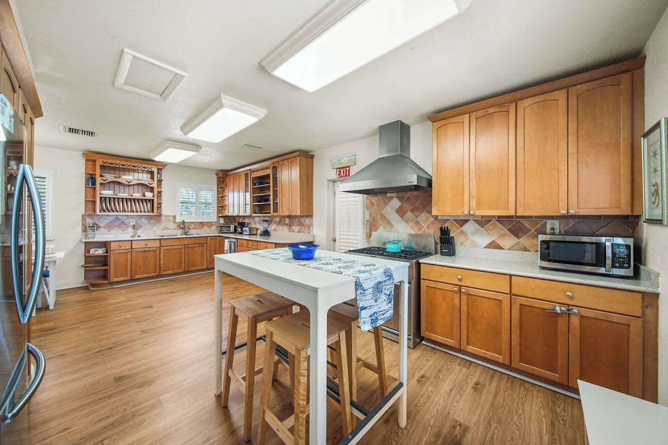 Spacious kitchen with modern amenities and a cozy island for casual dining, perfect for family gatherings.