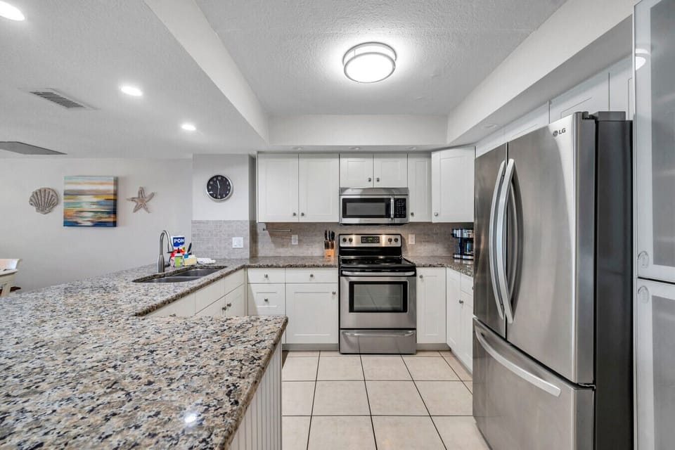 Another angle of the kitchen highlighting generous counter space and modern appliances.