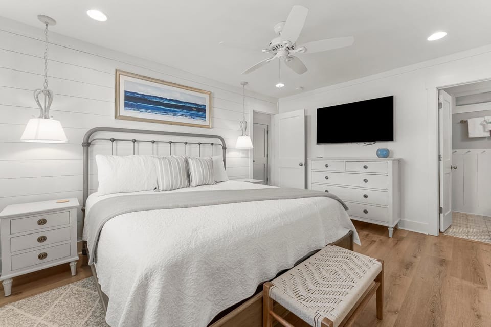 The bedroom features a King-sized bed, double closets, television, and ensuite bathroom.